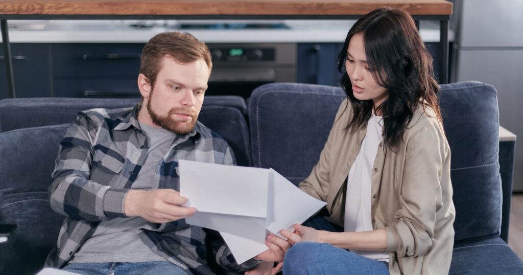 Couple reviewing account paperwork together to check their beneficiary designations