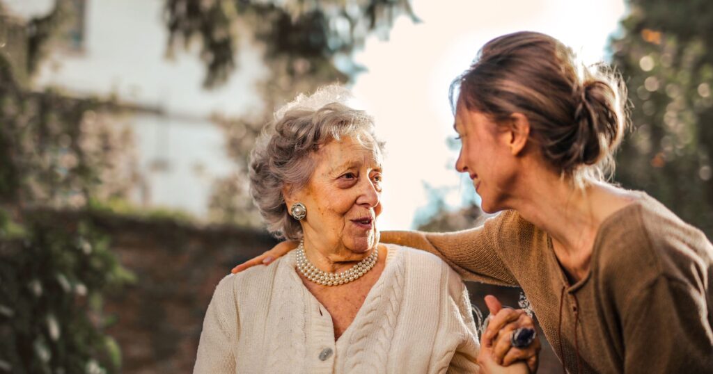 Adult daughter talking warmly with her elderly mother about organizing her important documents