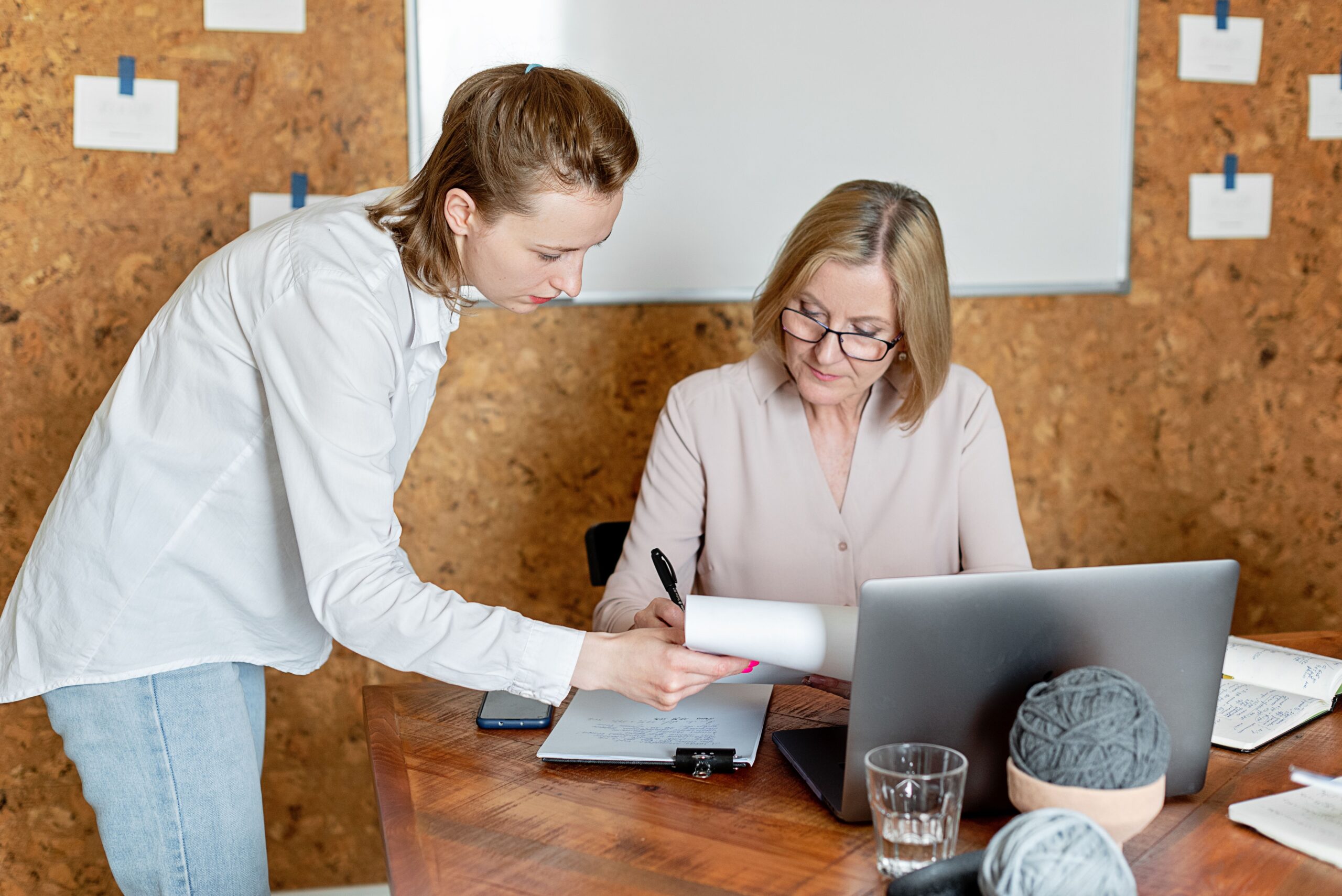 Older adult signing a durable power of attorney document with a legal adviser